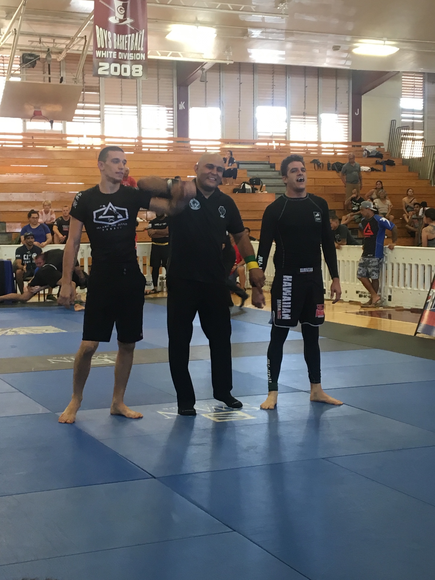 Referee raising the hand of an Island Jiu-Jitsu competitor after a win